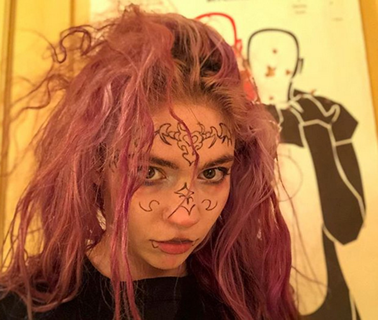 Grimes ear and face tattoos